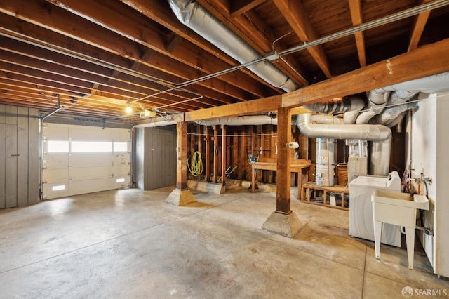basement with washer / clothes dryer and water heater