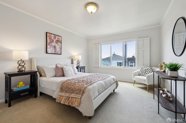 carpeted bedroom with ornamental molding and baseboards