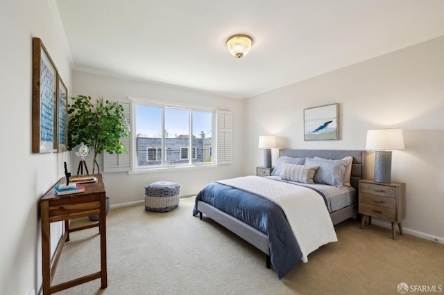 bedroom with light colored carpet, baseboards, and crown molding