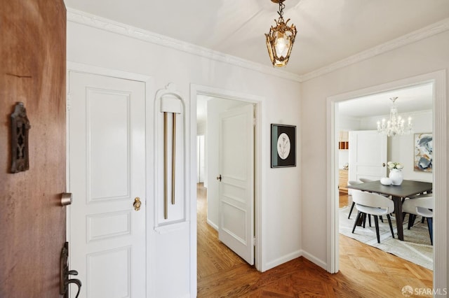 hallway featuring a chandelier, ornamental molding, and baseboards