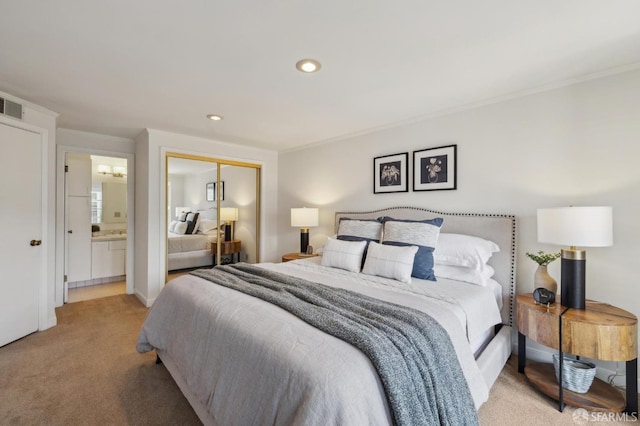 bedroom featuring light carpet, a closet, ensuite bath, recessed lighting, and crown molding