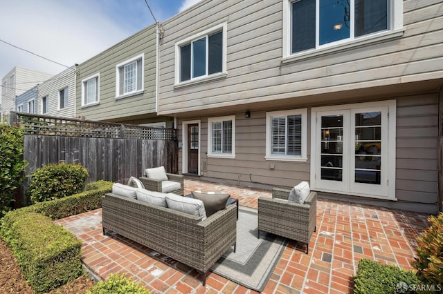 view of patio with fence, an outdoor hangout area, and french doors