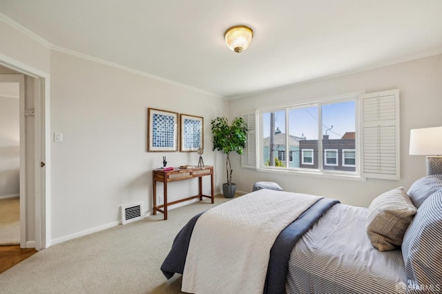 bedroom featuring carpet, ornamental molding, and baseboards