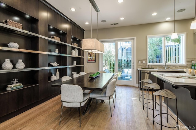 dining area featuring light wood finished floors, visible vents, and recessed lighting