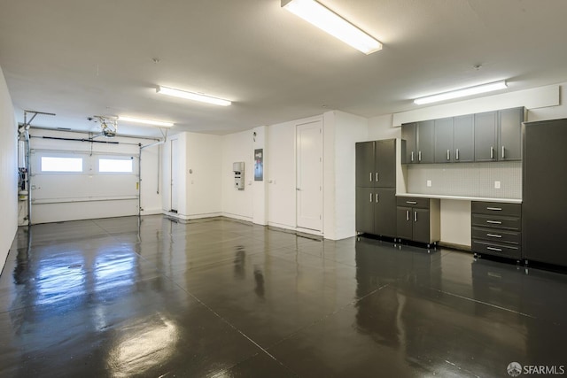 garage featuring a garage door opener and electric panel