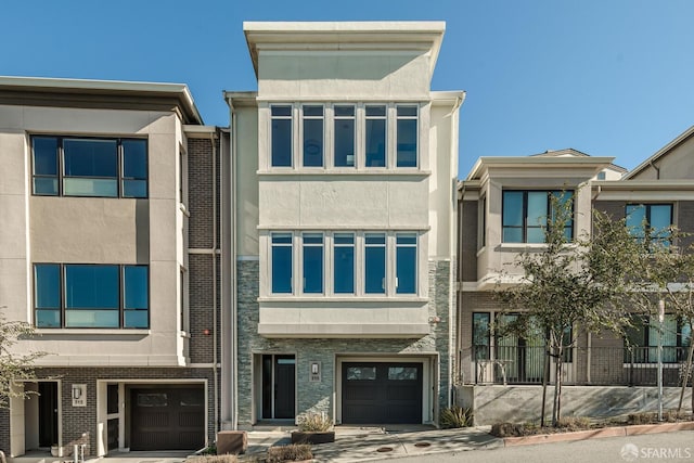 view of front facade with an attached garage and stucco siding