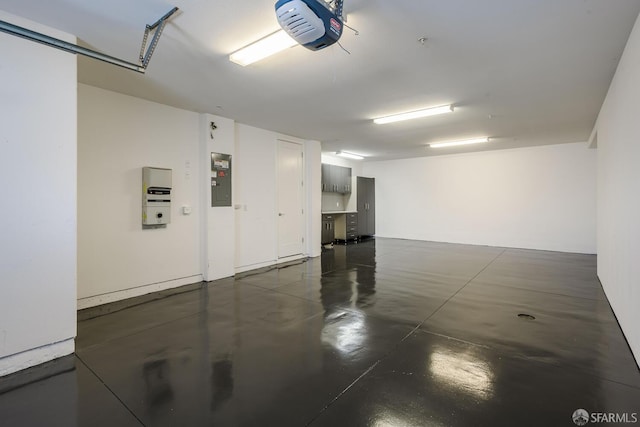 garage with electric panel and a garage door opener