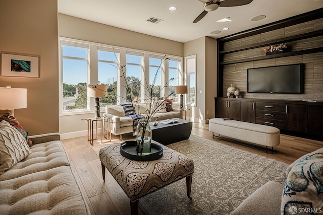 living area with baseboards, visible vents, ceiling fan, light wood-type flooring, and recessed lighting