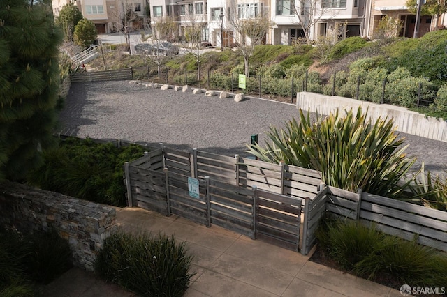 view of home's community featuring fence