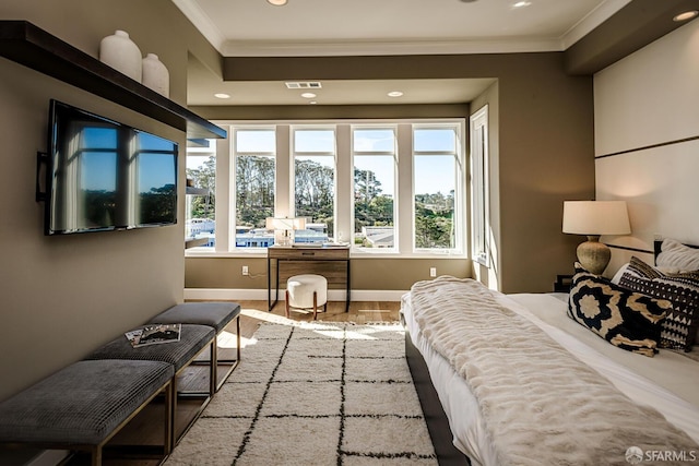 bedroom featuring baseboards, visible vents, wood finished floors, crown molding, and recessed lighting