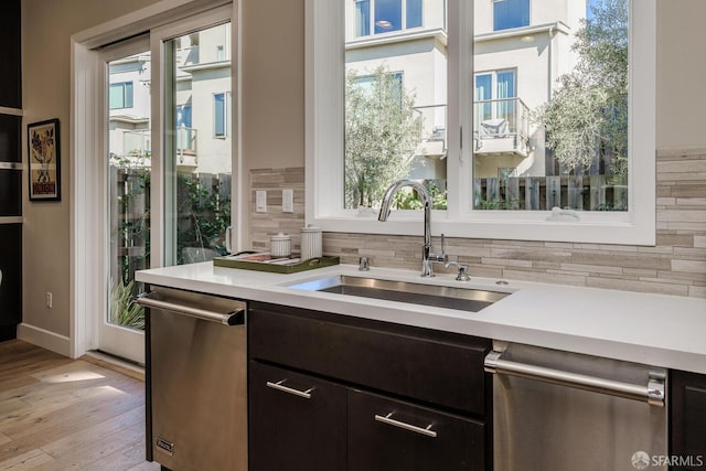 kitchen with stainless steel dishwasher, plenty of natural light, and a sink