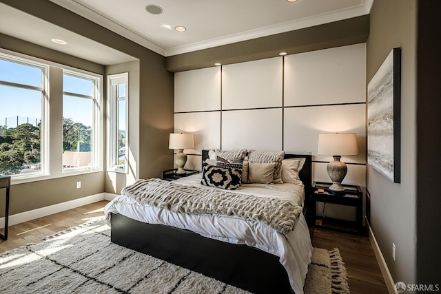 bedroom featuring ornamental molding, recessed lighting, wood finished floors, and baseboards