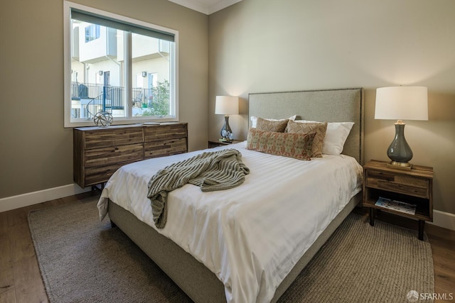 bedroom with wood finished floors and baseboards