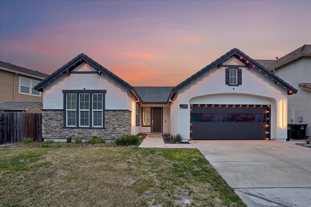 view of front of house with a garage and a yard