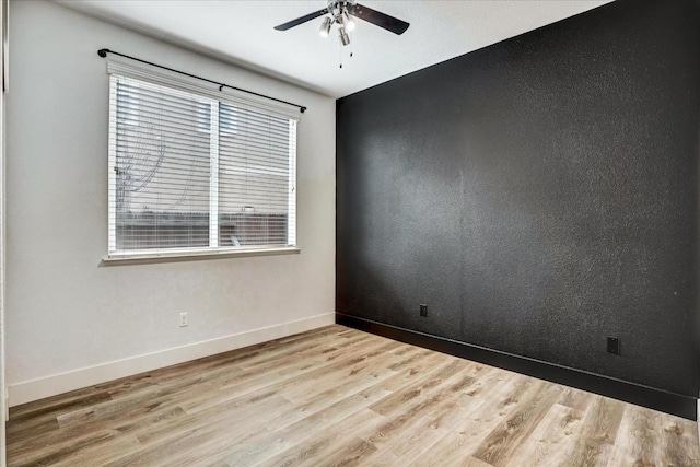 spare room featuring ceiling fan and light hardwood / wood-style flooring