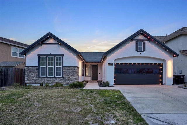 view of front of home with a yard and a garage