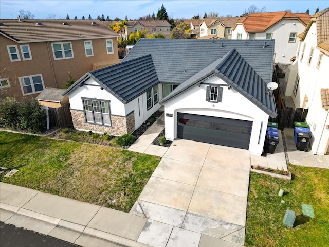 view of front of home with a garage and a front lawn