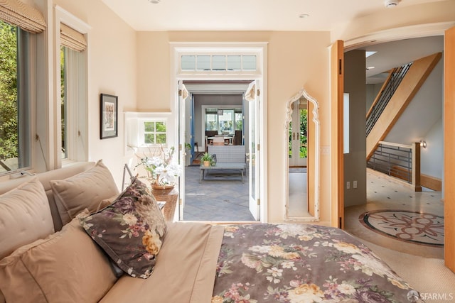 carpeted foyer entrance featuring stairway