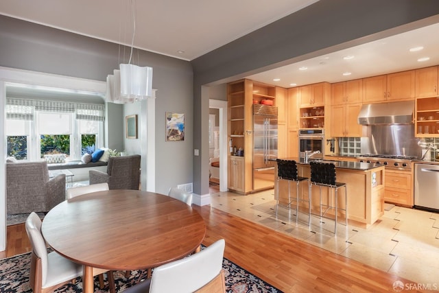 dining area featuring light wood-type flooring and recessed lighting