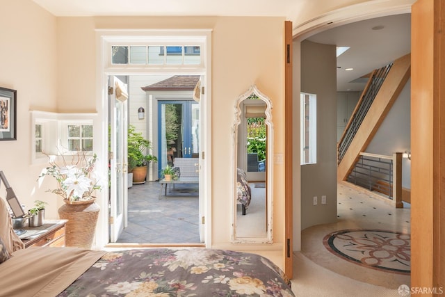 foyer with arched walkways and a towering ceiling