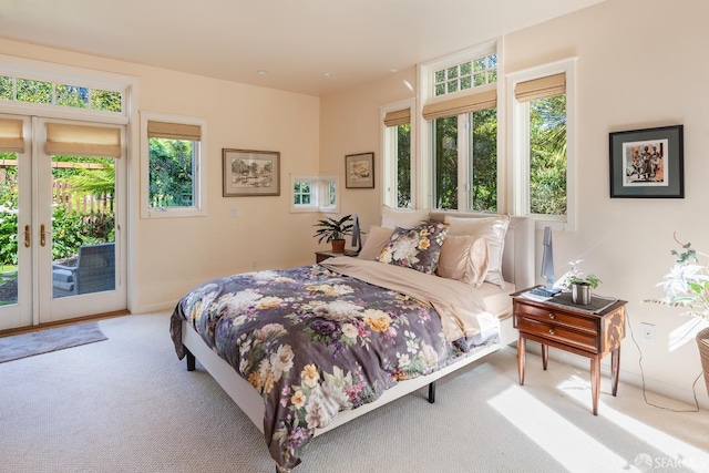 carpeted bedroom with access to exterior and french doors