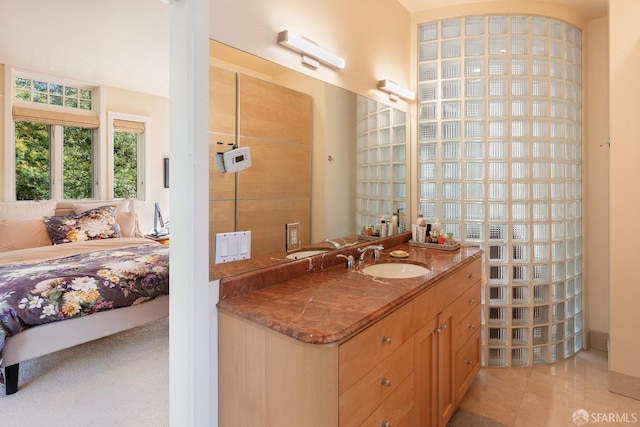 ensuite bathroom featuring vanity, tile patterned floors, and connected bathroom