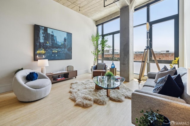 1 S Park St Unit 308, San Francisco, CA 94107 - living area with a wall of windows, baseboards, and wood finished floors
