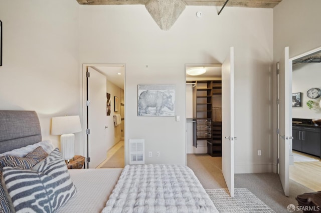 1 S Park St Unit 308, San Francisco, CA 94107 - bedroom featuring a spacious closet, light colored carpet, a towering ceiling, a closet, and connected bathroom