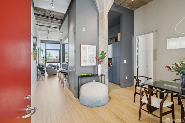 1 S Park St Unit 308, San Francisco, CA 94107 - hallway featuring a high ceiling, wood finished floors, rail lighting, expansive windows, and baseboards