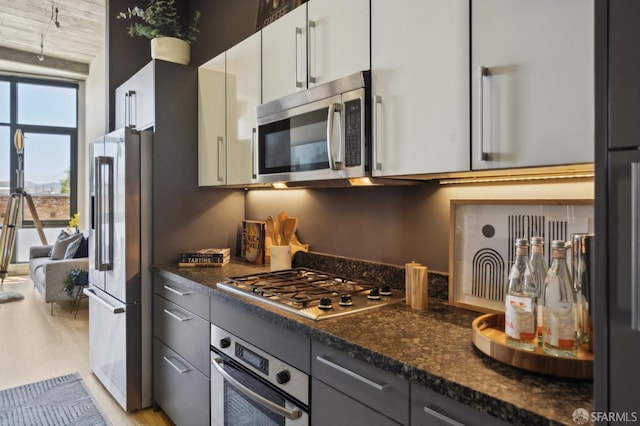 1 S Park St Unit 308, San Francisco, CA 94107 - kitchen with appliances with stainless steel finishes, light wood-style floors, white cabinets, and dark stone countertops