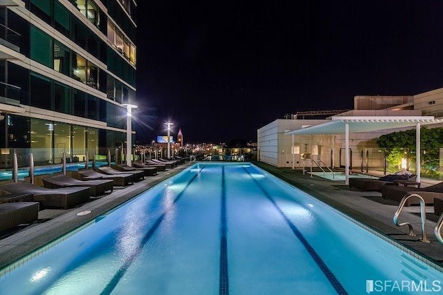 pool at night with a pergola