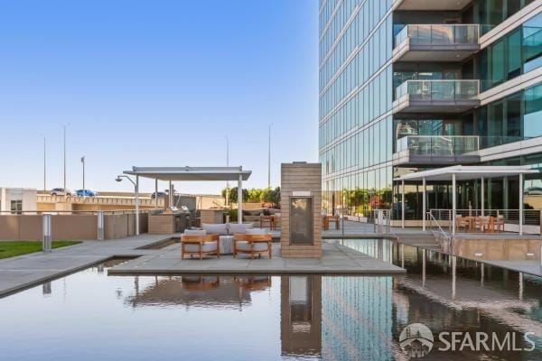 view of pool featuring a water view