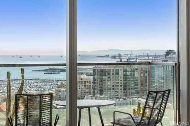 balcony featuring a water and mountain view