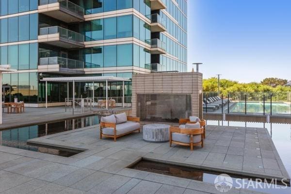 view of patio / terrace with an outdoor brick fireplace