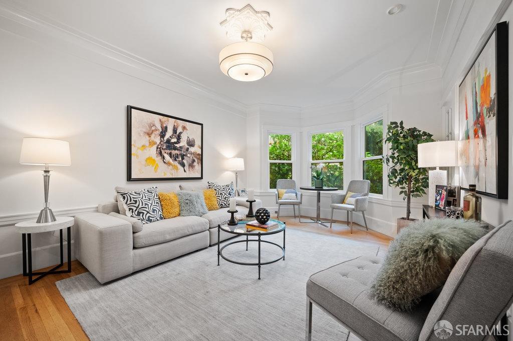 living room with light hardwood / wood-style floors and ornamental molding