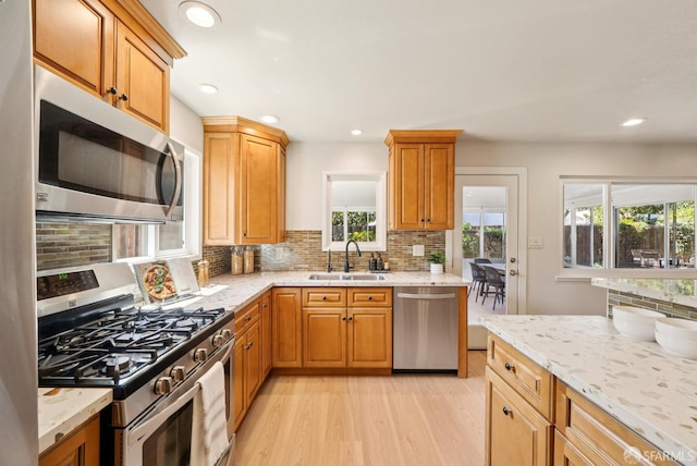 4649 Theta St, Fremont, CA 94536 - kitchen with stainless steel appliances, tasteful backsplash, light wood-style floors, light stone counters, and recessed lighting
