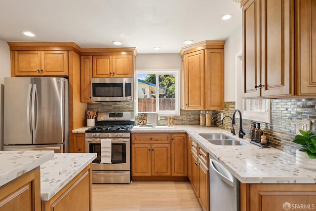 4649 Theta St, Fremont, CA 94536 - kitchen featuring stainless steel appliances, backsplash, light wood-type flooring, light stone countertops, and recessed lighting
