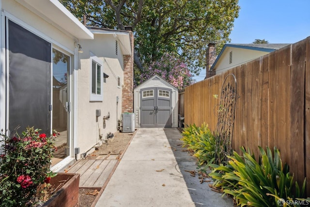 4649 Theta St, Fremont, CA 94536 - view of side of home with a storage unit, stucco siding, a deck, and a chimney