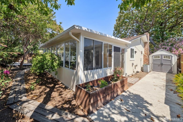 4649 Theta St, Fremont, CA 94536 - view of front of house featuring a storage unit, a sunroom, concrete driveway, and a chimney