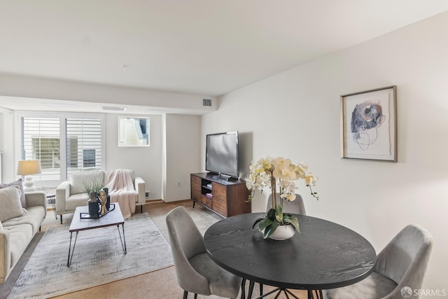 dining area featuring light colored carpet