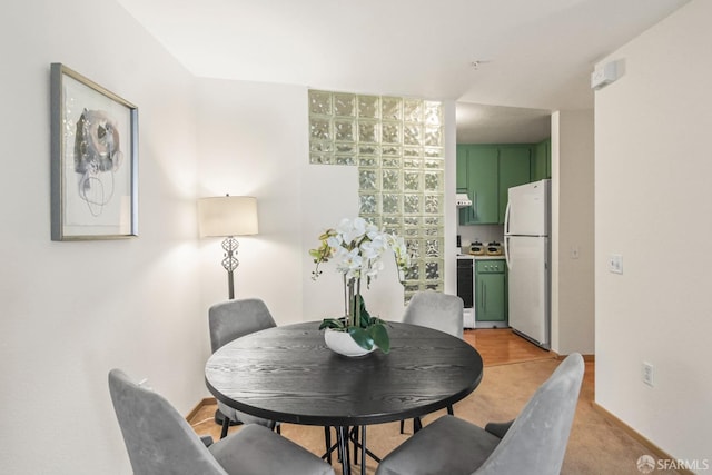 dining area with light colored carpet