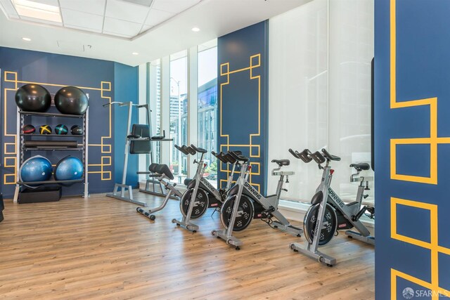 401 Harrison St Unit 25F, San Francisco, CA 94105 - gym with a wall of windows, wood finished floors, and recessed lighting