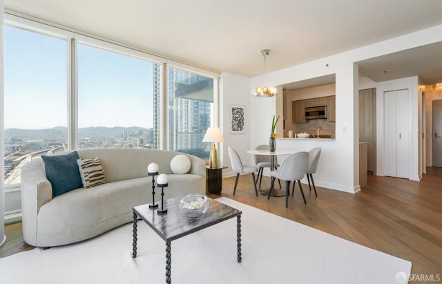 401 Harrison St Unit 25F, San Francisco, CA 94105 - living room featuring wood finished floors and a chandelier