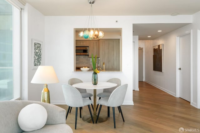 401 Harrison St Unit 25F, San Francisco, CA 94105 - dining area featuring baseboards, wood finished floors, a chandelier, and recessed lighting