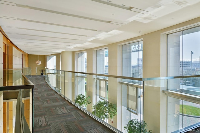 hallway featuring dark colored carpet