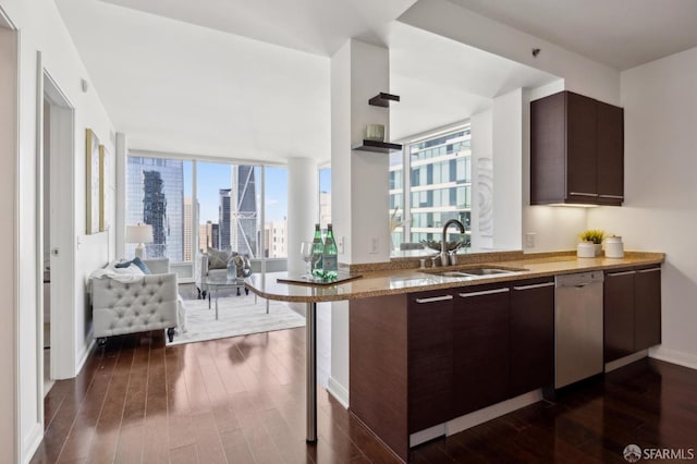 kitchen with dark hardwood / wood-style floors, sink, stainless steel dishwasher, kitchen peninsula, and dark brown cabinets