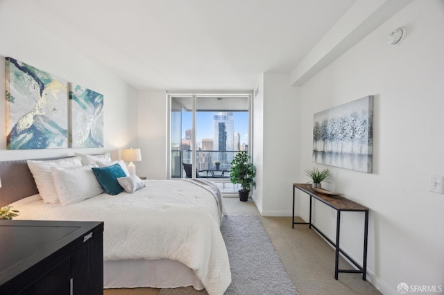 bedroom with access to exterior and light colored carpet