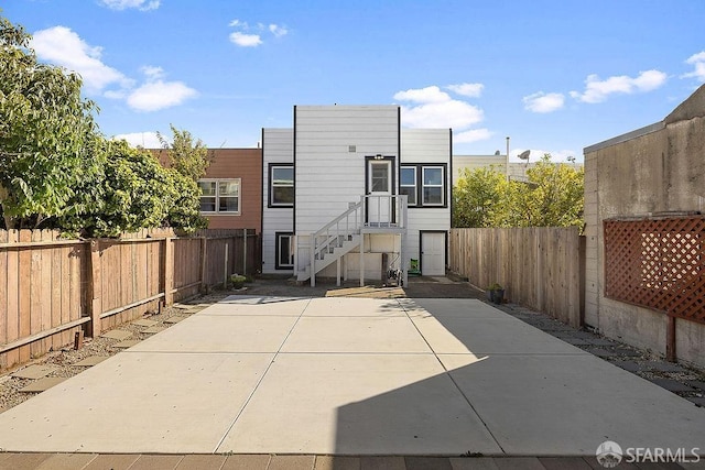 back of house featuring a patio area and a fenced backyard