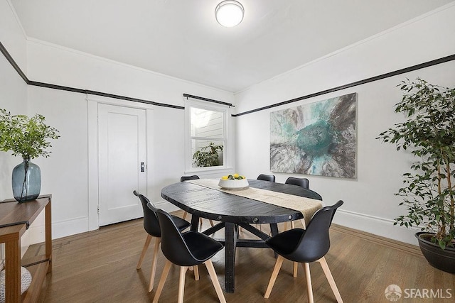 dining room featuring baseboards and wood finished floors