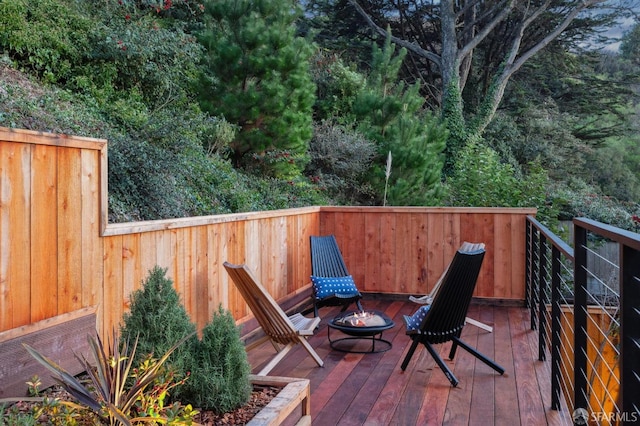 wooden deck with a fire pit